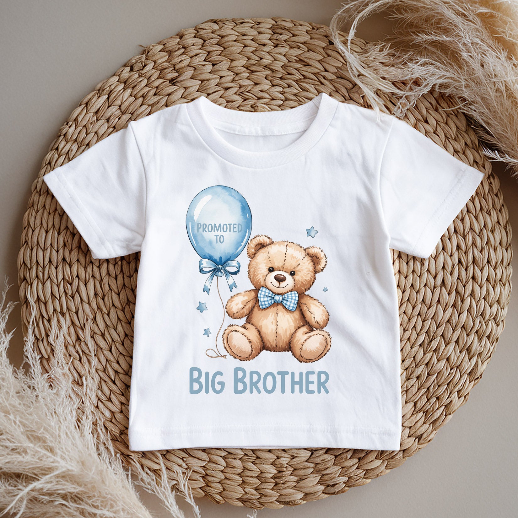 White big brother t-shirt with teddy bear and balloon design on a woven mat