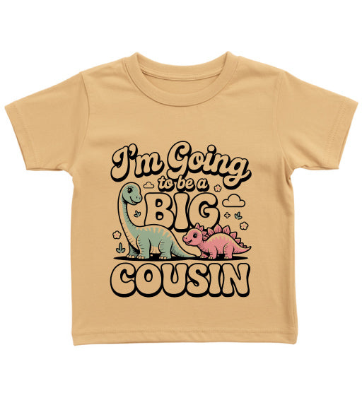 Beige t-shirt with dinosaur graphics and text 'I'm Going to be a Big Cousin' on a white background